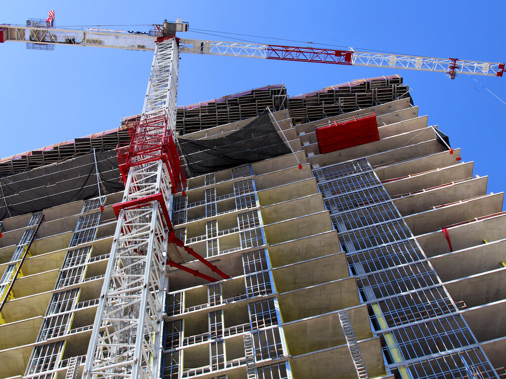 High-rise commercial building under construction with a tower crane